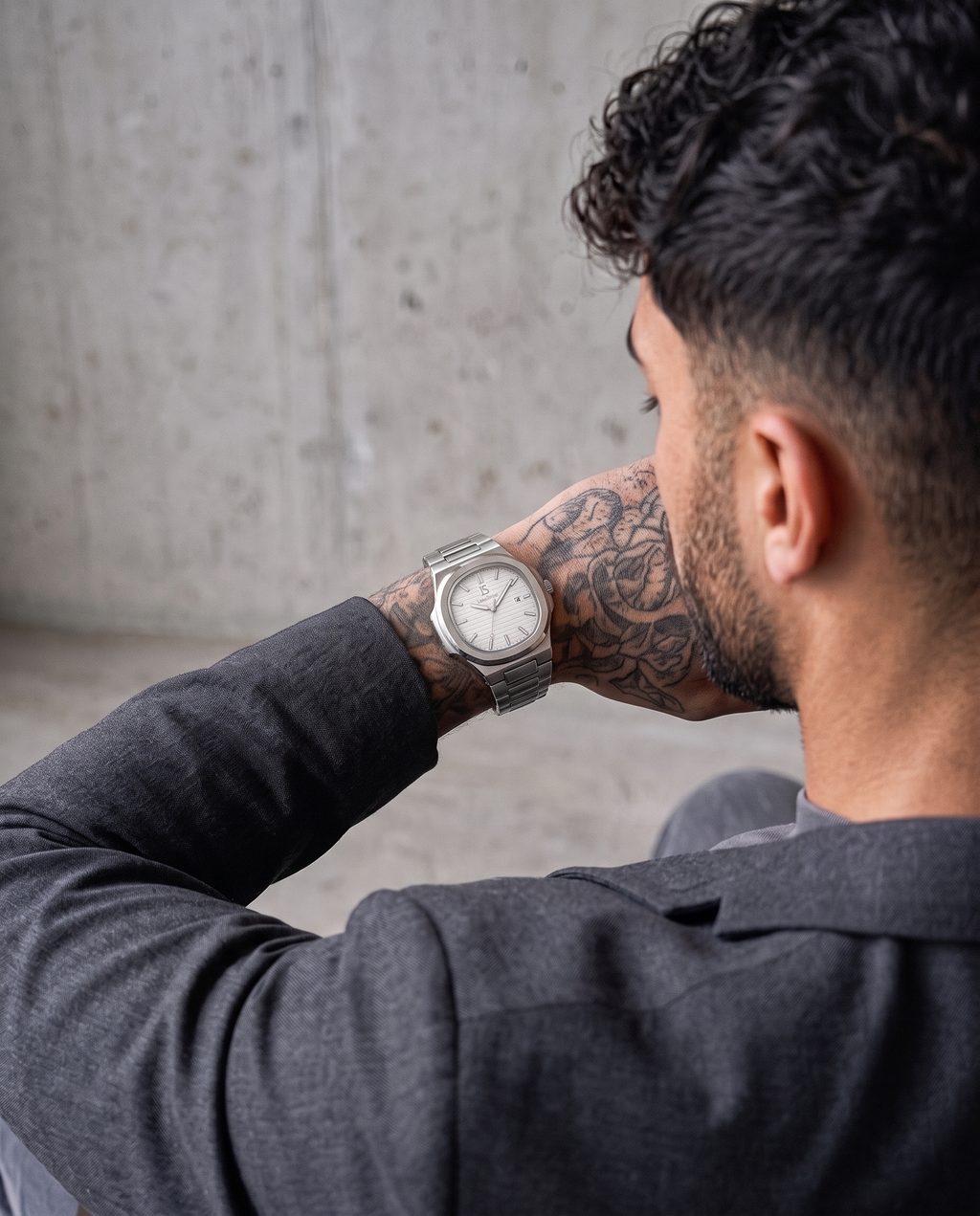 AI-GENERATED | source: Higgsfield nano_banana_2 | purpose: lifestyle-back | product: CASPIAN | variant: Arctic Silver | variant_id: gid://shopify/ProductVariant/52455819018529 | model: approved-luxe-male-20260707 | date: 2026-07-15 | target: PDP gallery lifestyle